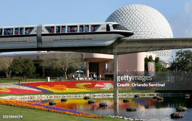 In this March 19, 2009 file photo, a Disney World monorail passes Spaceship Earth at Walt Disney World's Epcot Center in Lake Buena Vista, Fla....