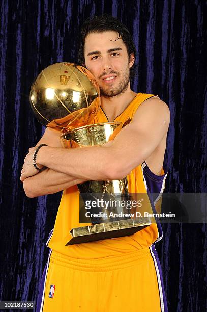 Sasha Vujacic of the Los Angeles Lakers holds the Larry O'Brien Trophy following his team's victory over the Boston Celtics in Game Seven of the 2010...