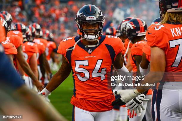 Linebacker Brandon Marshall of the Denver Broncos runs onto the field as players are introduced before an NFL preseason game against the Chicago...