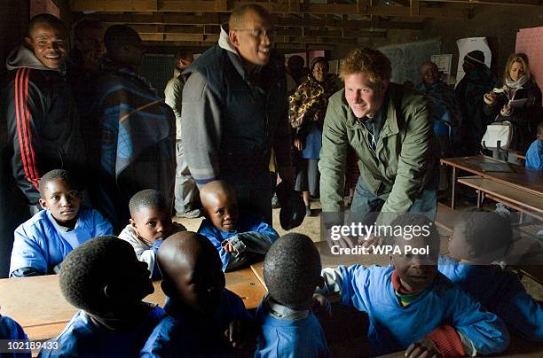 Prince Harry opens a classroom and talks and dances with schoolchildren accompanied by Prince Seeiso of Lesotho on June 16, 2010 in the village of...