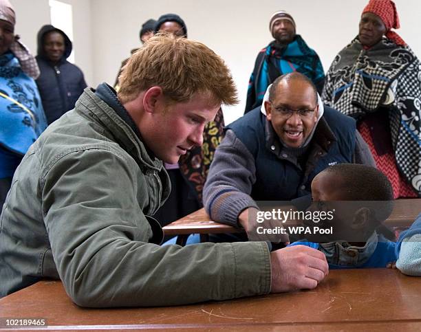 Prince Harry opens a classroom and talks and dances with schoolchildren accompanied by Prince Seeiso of Lesotho on June 16, 2010 in the village of...