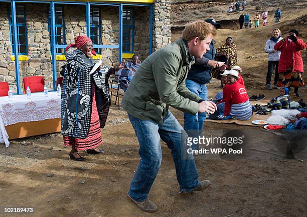 Prince Harry opens a classroom and talks and dances with schoolchildren accompanied by Prince Seeiso of Lesotho on June 16, 2010 in the village of...