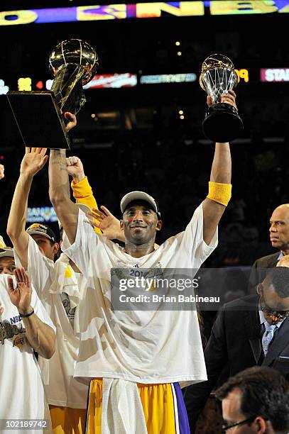 Kobe Bryant of the Los Angeles Lakers celebrates with the Larry O'Brien and Bill Russell Finals MVP Trophies after defeating the Boston Celtics 83-79...