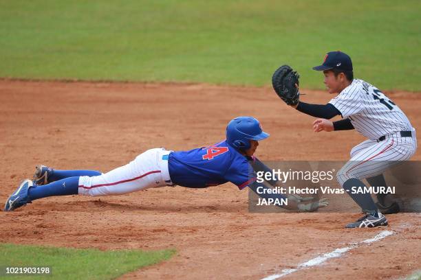 Tung-Sen Li of Chinese Taipei slides safely into first base against Hiromu Joshita of Japan in the 3rd inning during the Bronze Medal match of WSBC...