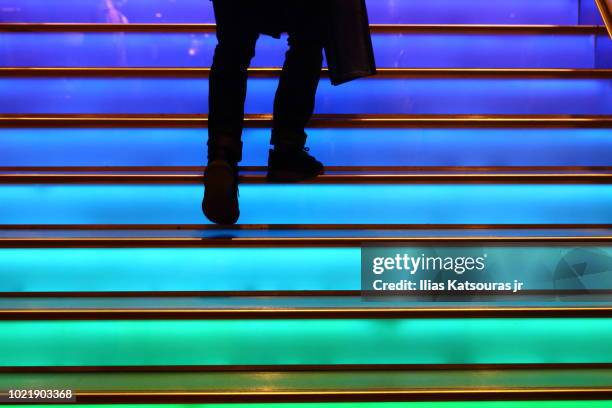 person walking up colorful staircase - november 1 2017 stock-fotos und bilder