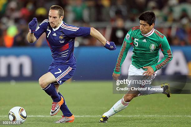Franck Ribery of France is followed by Ricardo Osorio of Mexico during the 2010 FIFA World Cup South Africa Group A match between France and Mexico...