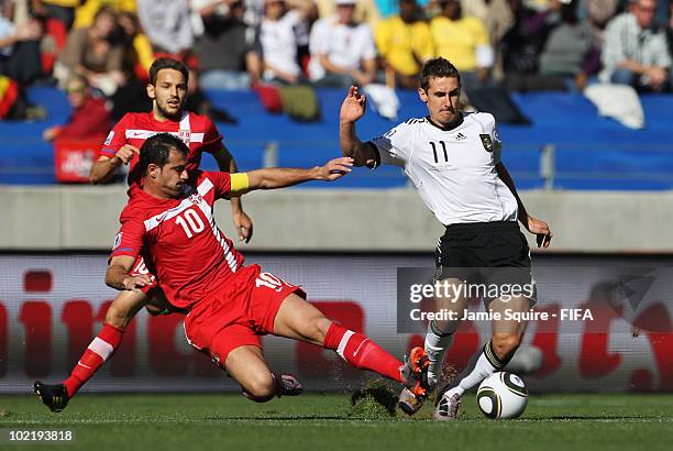 Dejan Stankovic of Serbia challenges Miroslav Klose of Germany during the 2010 FIFA World Cup South Africa Group D match between Germany and Serbia...
