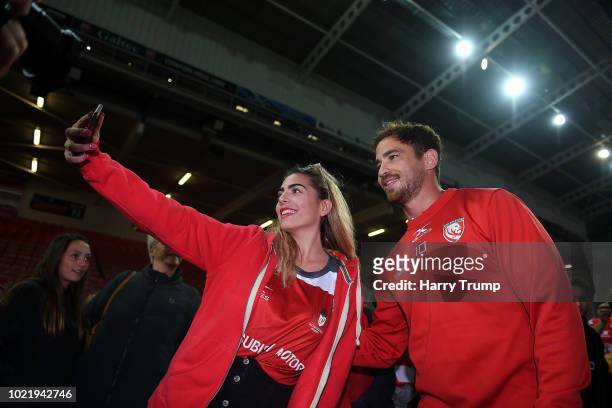 Danny Cipriani of Gloucester Rugby poses for a photo with a fan during the Pre Season Friendly match between Gloucester Rugby and Dragons at...