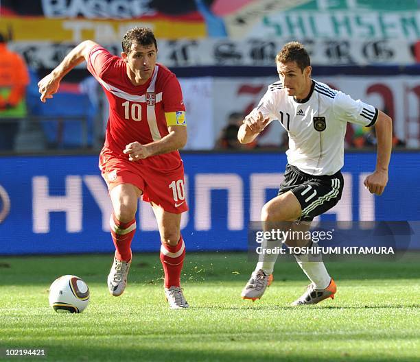 Germany's striker Miroslav Klose fights for the ball with Serbia's midfielder Dejan Stankovic during the Group D first round 2010 World Cup football...