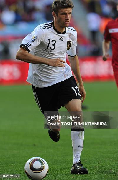 Germany's midfielder Thomas Mueller runs with the ball during the Group D first round 2010 World Cup football match Germany vs. Serbia on June 18,...