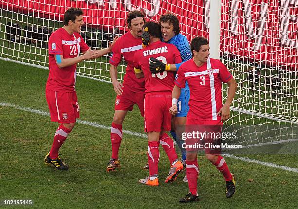Goalkeeper Vladimir Stojkovic of Serbia celebrates with captain Dejan Stankovic after he saved a penalty from Lukas Podolski during the 2010 FIFA...