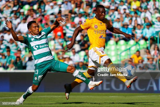 Jose Vazquez of Santos and Julian Quiñones of Tigres fight for the ball during the fifth round match between Santos Laguna and Tigres UANL as part of...