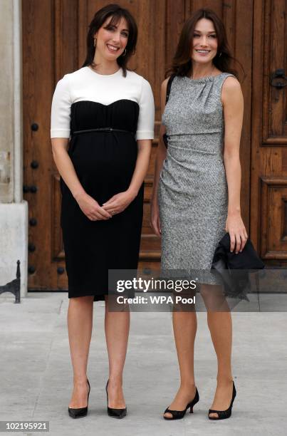 Samantha Cameron, wife of British Prime Minister David Cameron greets Carla Bruni-Sarkozy, wife of President Nicolas Sarkozy at the Royal Chelsea...