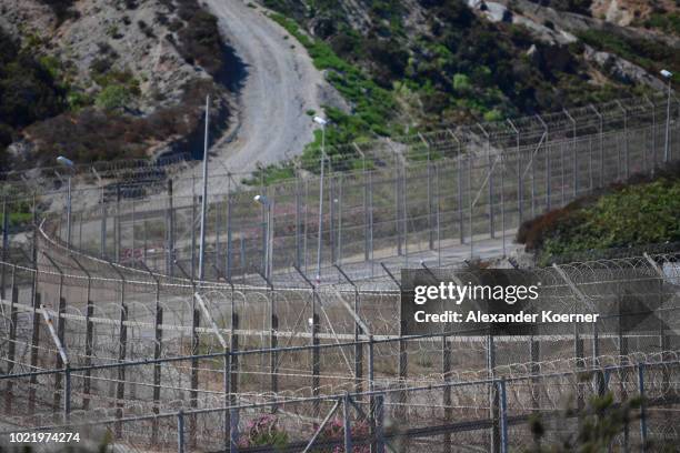 General view of the border fence separating the Spanish exclave of Ceuta from Morocco on August 23, 2018 in Ceuta, Spain. Many migrants are seeking...