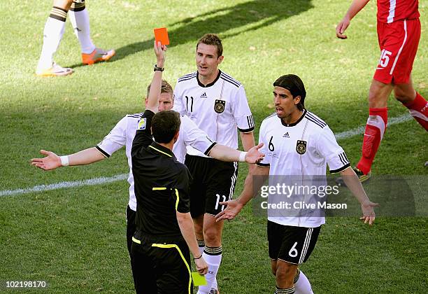 Miroslav Klose of Germany is awarded a second yellow card and is sent off by referee Alberto Undiano as Bastian Schweinsteiger of Germany appeals...