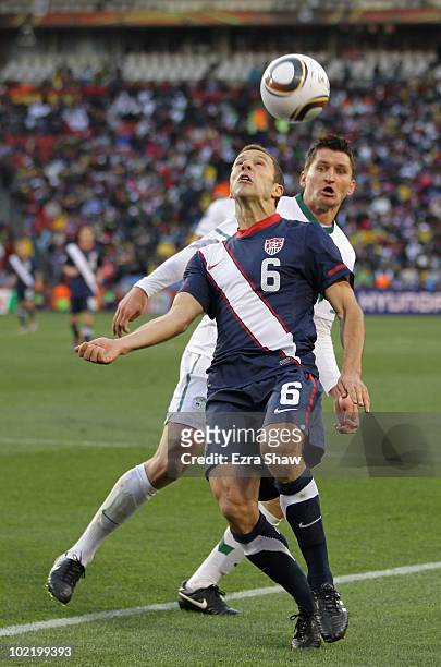 Andraz Kirm of Slovenia challenges Steve Cherundolo of the United States during the 2010 FIFA World Cup South Africa Group C match between Slovenia...