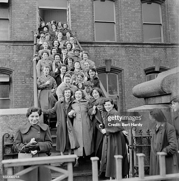 Workers leaving the Tillie and Henderson's shirt factory in Derry, Northern Ireland, November 1955. Original publication: Picture Post - 8199 - One...