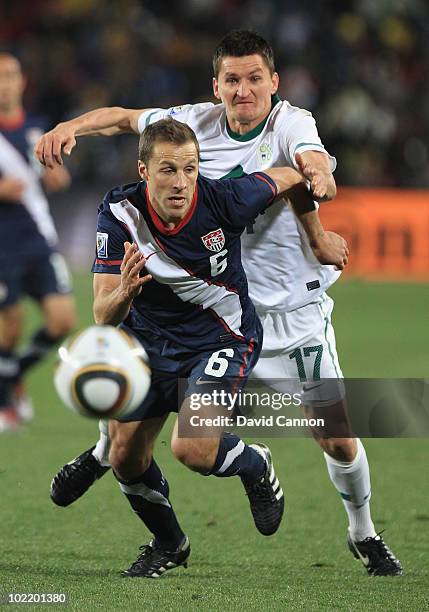 Steve Cherundolo of the United States is challenged by Andraz Kirm of Slovenia during the 2010 FIFA World Cup South Africa Group C match between...