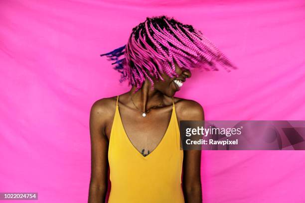 Girl shaking her pink braided hair