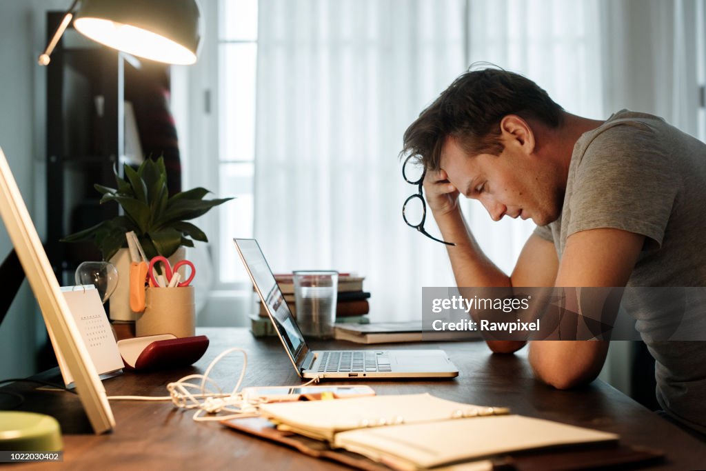 Man stressed while working on laptop