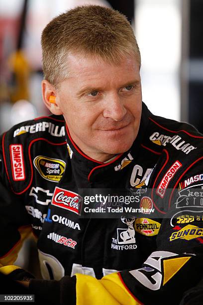 Jeff Burton, driver of the CAT Chevrolet, stands in the garage area during practice for the NASCAR Sprint Cup Series Toyota/Save Mart 350 at the...