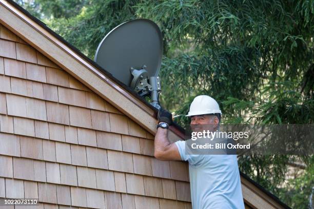 man installing satellite dish - satellite dish home stock pictures, royalty-free photos & images