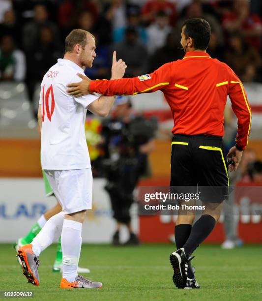 Wayne Rooney of England makes a point to to referee Ravshan Irmatov during the 2010 FIFA World Cup South Africa Group C match between England and...