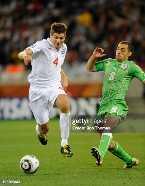 Steven Gerrard of England challenged by Medhi Lacen of Algeria during the 2010 FIFA World Cup South Africa Group C match between England and Algeria...