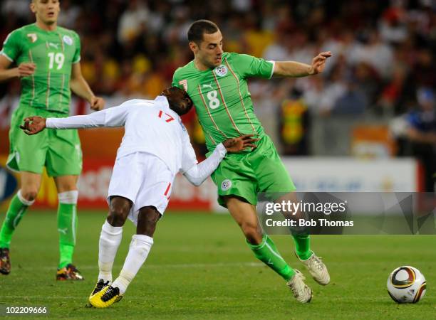 Medhi Lacen of Algeria traps the head of Shaun Wright-Phillips of England during the 2010 FIFA World Cup South Africa Group C match between England...