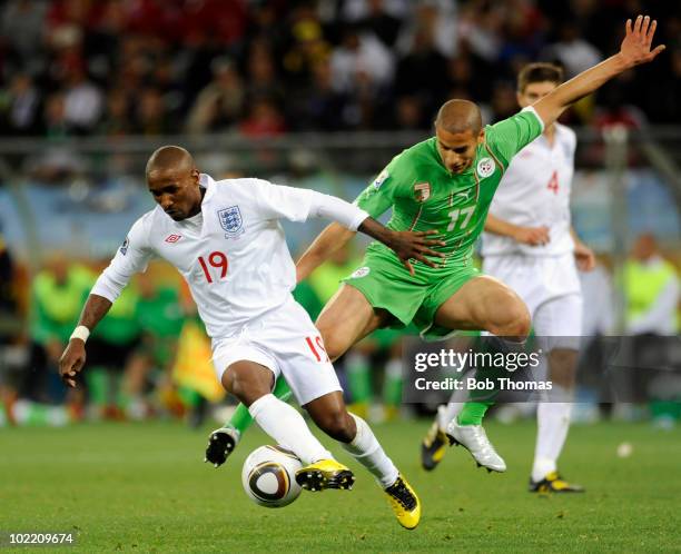 Jermain Defoe of England challenged by Adlane Guedioura of Algeria during the 2010 FIFA World Cup South Africa Group C match between England and...