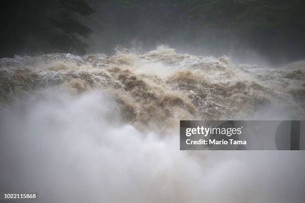 The Wailuku River flood waters run downstream on the Big Island on August 23, 2018 in Hilo, Hawaii. Hurricane Lane has brought more than a foot of...