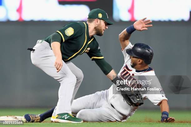 Eddie Rosario of the Minnesota Twins steals second base as Jed Lowrie of the Oakland Athletics applies the tag during the third inning of the game on...