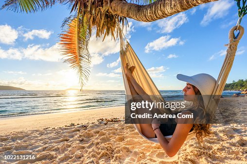 A beautiful woman on a tropical beach, sleeps in a hammock