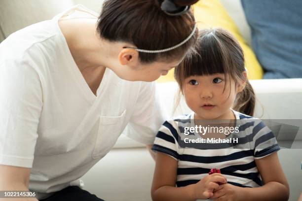 mother and daughter are looking at each other - japanese girl fotografías e imágenes de stock