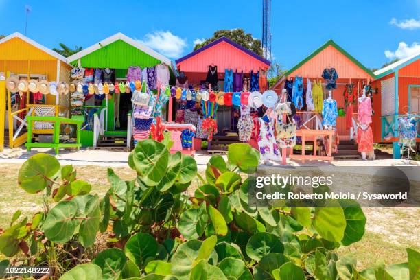 multi colored wood cottages and tourist souvenir shops, long bay beach, antigua - caribbean culture fotografías e imágenes de stock