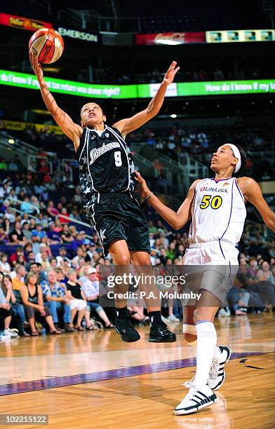 Edwige Lawson-Wade of the San Antonio Silver Stars shoots as Tangela Smith of the Phoenix Mercury defends on June 18, 2010 at U.S. Airways Center in...