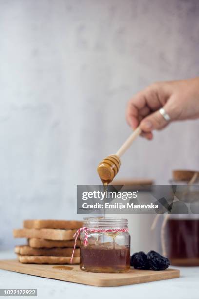 honey in a small jar - honey-bird stock pictures, royalty-free photos & images
