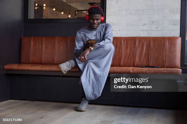 young african man using tablet in cafe - kaftan stock-fotos und bilder