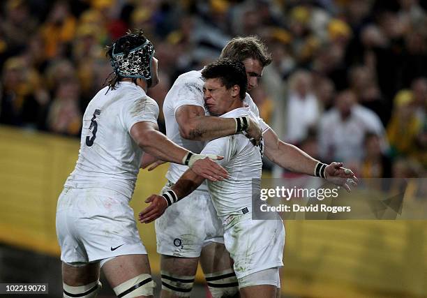 Ben Youngs of England is congratulated by team mates Tom Palmer and Tom Croft after scoring the first try during the Cook Cup Test Match between the...