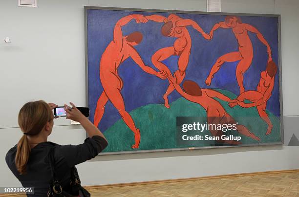 Visitor takes a picture of the painting "Dance" by Henri Matisse at the State Hermitage museum on June 19, 2010 in St. Petersburg, Russia. The State...