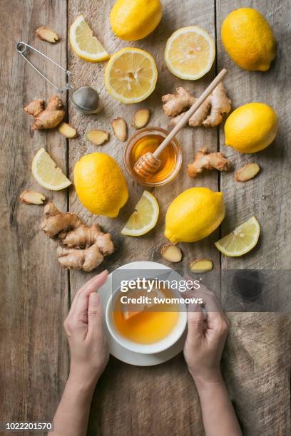 flat lay honey lemon ginger tea. - ginger tea stock pictures, royalty-free photos & images