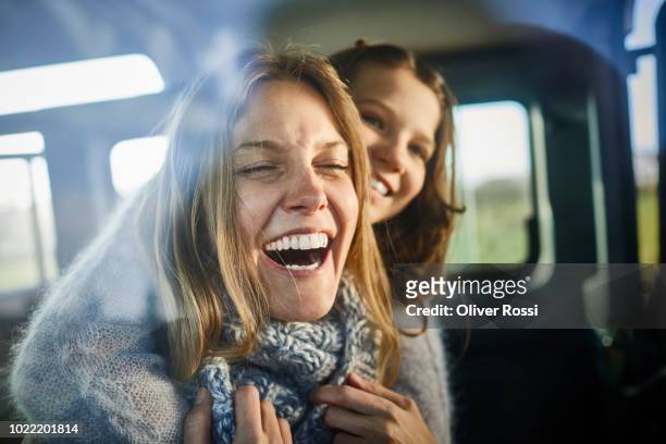 happy mother and daughter inside off-road vehicle - lachen stock-fotos und bilder