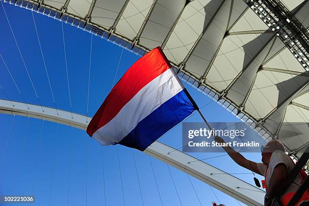 Netherlands fan waves a flag as he enjoys the atmosphere prior to the 2010 FIFA World Cup South Africa Group E match between Netherlands and Japan at...