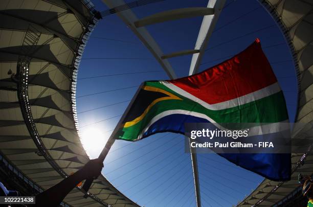 Fan waves a South African flag as he enjoys the atmosphere during the 2010 FIFA World Cup South Africa Group E match between Netherlands and Japan at...