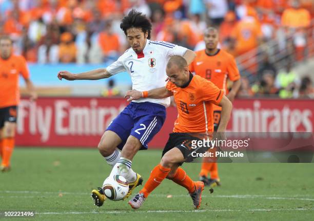 Yuki Abe of Japan tackles Wesley Sneijder of the Netherlands during the 2010 FIFA World Cup South Africa Group E match between Netherlands and Japan...