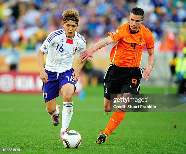 Robin Van Persie of the Netherlands pressures Yoshito Okubo of Japan during the 2010 FIFA World Cup South Africa Group E match between Netherlands...