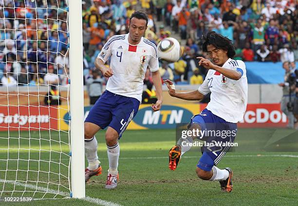 Marcus Tulio Tanaka and Yuji Nakazawa of Japan clear the ball from the goal mouth during the 2010 FIFA World Cup South Africa Group E match between...