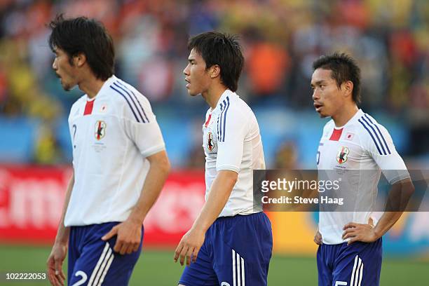 Yuki Abe, Shinji Okazaki and Yuto Nagatomo of Japan are dejected after defeat in the 2010 FIFA World Cup South Africa Group E match between...