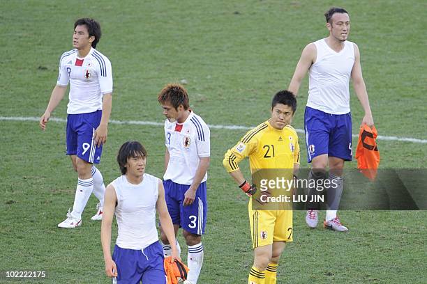 Japan's striker Shinji Okazaki , Japan's defender Yuichi Komano , Japan's goalkeeper Eiji Kawashima and Japan's defender Marcus Tulio Tanaka react...