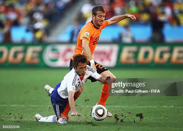 Yuichi Komano of Japan is tackled by Rafael Van der Vaart of the Netherlands during the 2010 FIFA World Cup South Africa Group E match between...